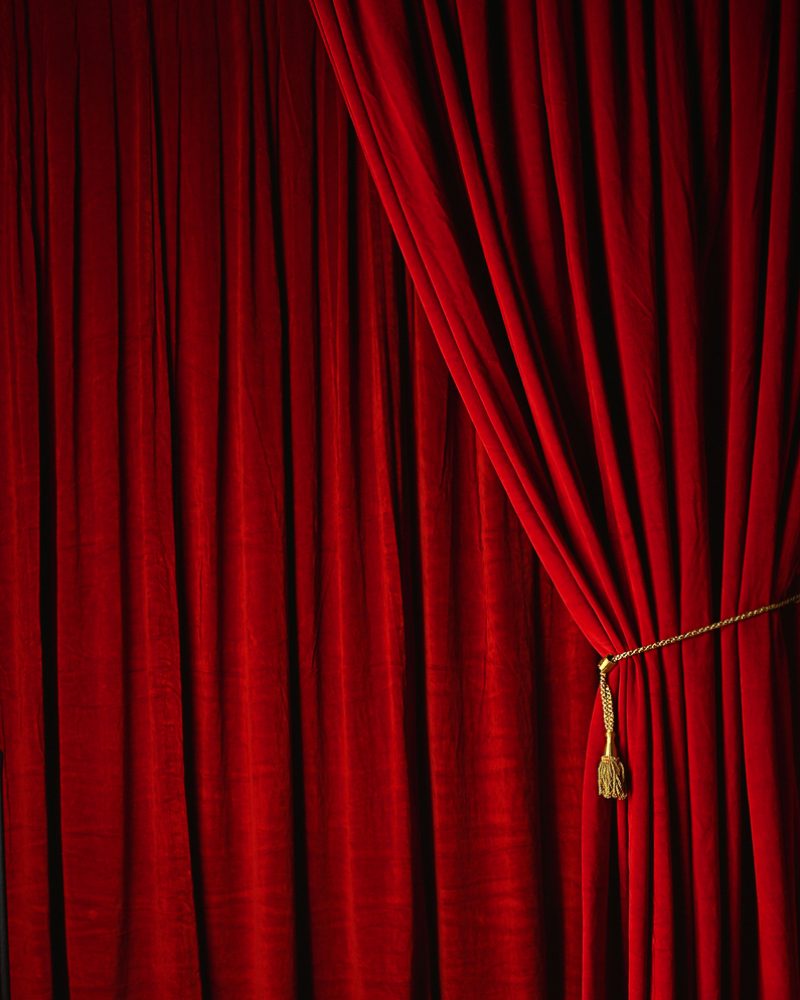 Red stage curtains at a theater